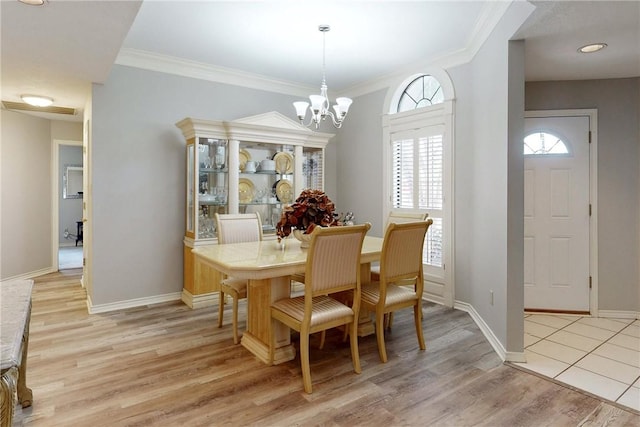3900 Puffin Way, College Station, TX 77845 - dining space with a chandelier, light wood-type flooring, baseboards, and ornamental molding