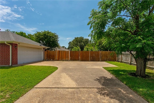 3900 Puffin Way, College Station, TX 77845 - view of yard featuring a garage