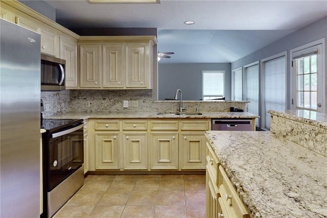 3900 Puffin Way, College Station, TX 77845 - kitchen featuring stainless steel appliances, a sink, cream cabinets, and light tile patterned floors