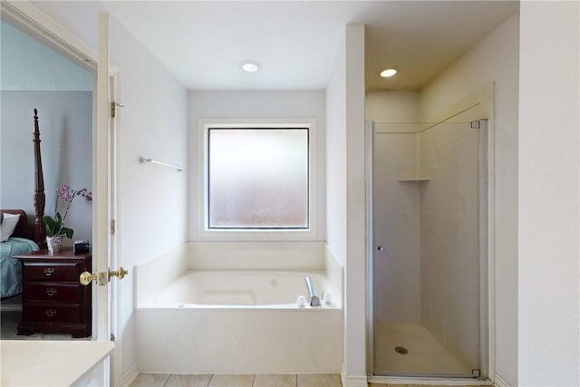 3900 Puffin Way, College Station, TX 77845 - ensuite bathroom featuring a garden tub, a stall shower, vanity, and tile patterned floors