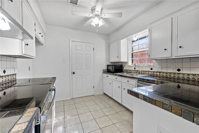 kitchen featuring white cabinets, sink, decorative backsplash, ceiling fan, and light tile patterned floors