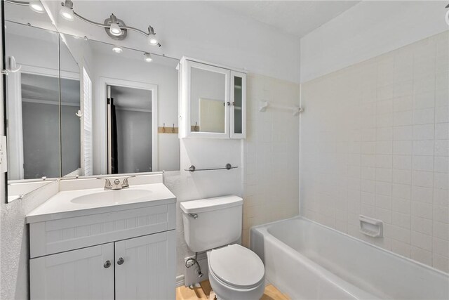 full bathroom with vanity, toilet, and tiled shower / bath combo