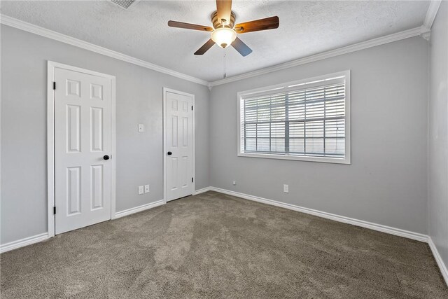 carpeted empty room with a textured ceiling, ceiling fan, and crown molding