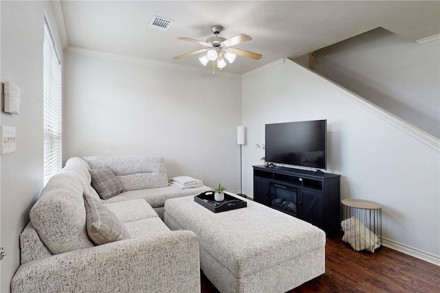 130 Forest Dr, College Station, TX 77840 - living area with ceiling fan, dark wood-type flooring, baseboards, and crown molding