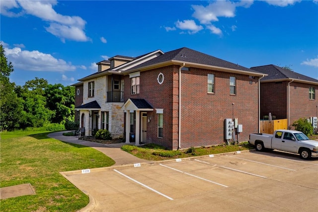 130 Forest Dr, College Station, TX 77840 - view of front of property featuring uncovered parking, a front lawn, and brick siding