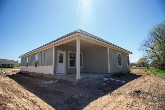 2581 Dove Xing, Navasota, TX 77868 - rear view of property featuring board and batten siding and a patio