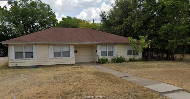 ranch-style house with a front lawn