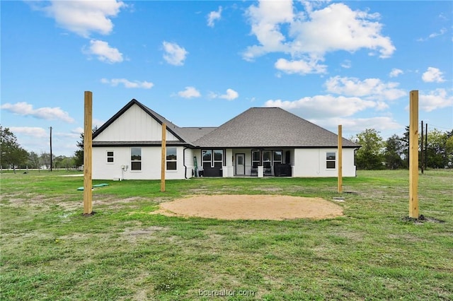 rear view of property with a yard