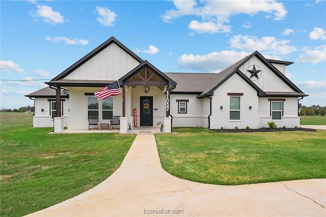 view of front of home with a porch and a front yard