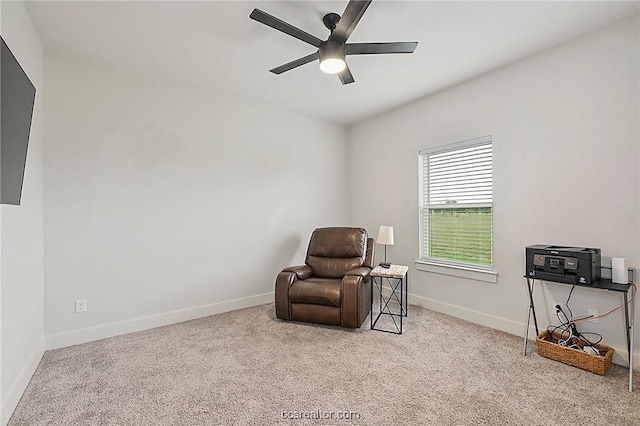 living area featuring light carpet and ceiling fan