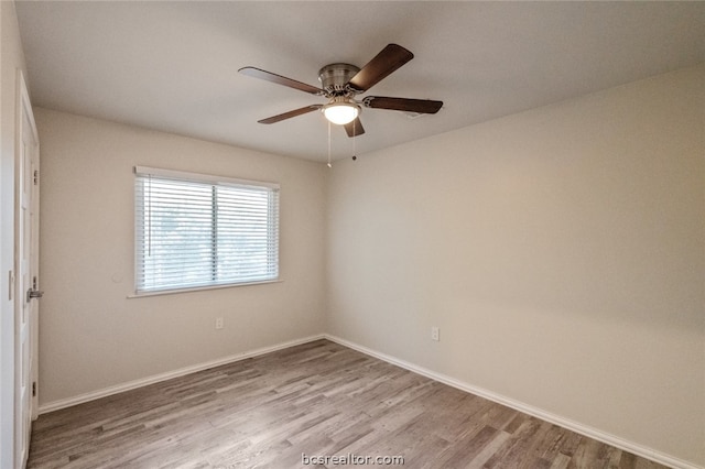 empty room with hardwood / wood-style floors and ceiling fan