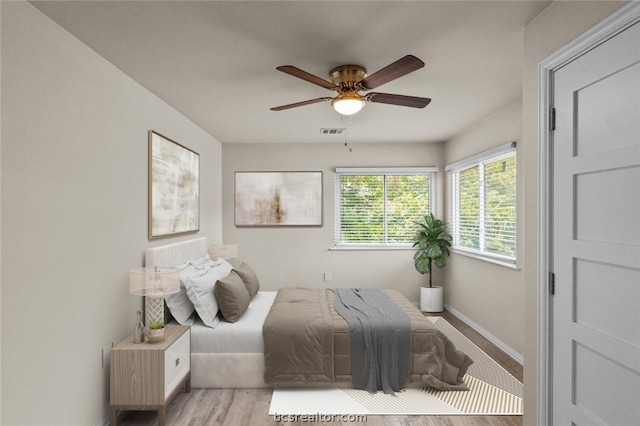 bedroom with ceiling fan and light hardwood / wood-style flooring