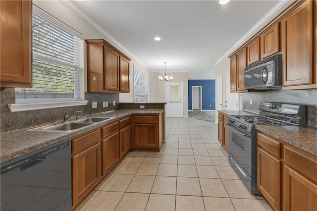 kitchen with pendant lighting, an inviting chandelier, black appliances, sink, and light tile patterned floors