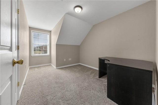 bonus room featuring light colored carpet and vaulted ceiling