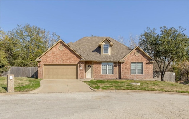 view of front facade featuring a front yard and a garage