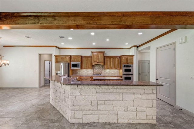 4662 Hidden Springs Way, College Station, TX 77845 - kitchen featuring stainless steel appliances, a spacious island, backsplash, ornamental molding, and dark stone counters