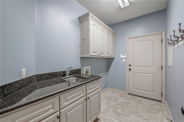 4662 Hidden Springs Way, College Station, TX 77845 - laundry room featuring cabinet space, electric dryer hookup, washer hookup, and baseboards