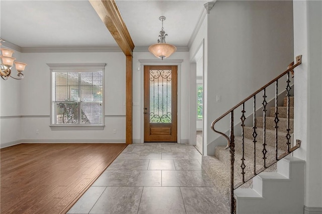 4662 Hidden Springs Way, College Station, TX 77845 - entryway with plenty of natural light, crown molding, stairway, a chandelier, and baseboards