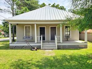 102 S Scott St, Fayetteville, TX 78940 - back of property with covered porch, a lawn, a standing seam roof, and metal roof