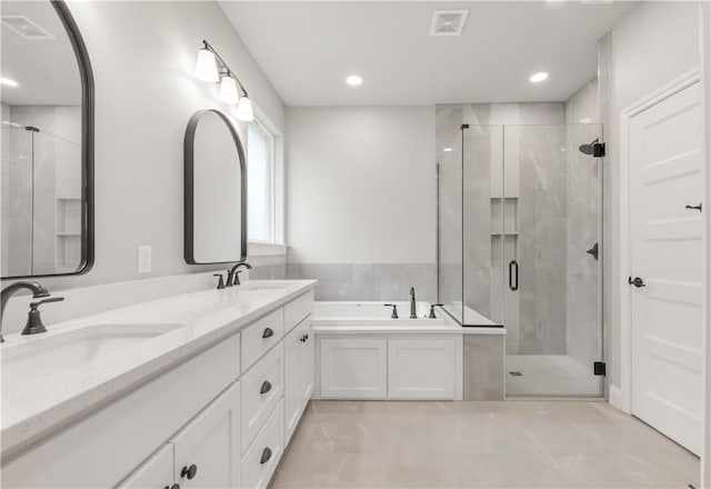 3013 Teller Dr, Bryan, TX 77808 - full bath featuring visible vents, a sink, a bath, and a stall shower