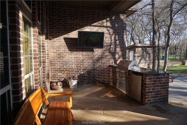 view of patio / terrace featuring area for grilling and a grill