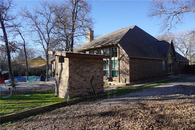 view of side of property with a patio area