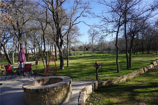 view of home's community featuring a lawn and a patio area