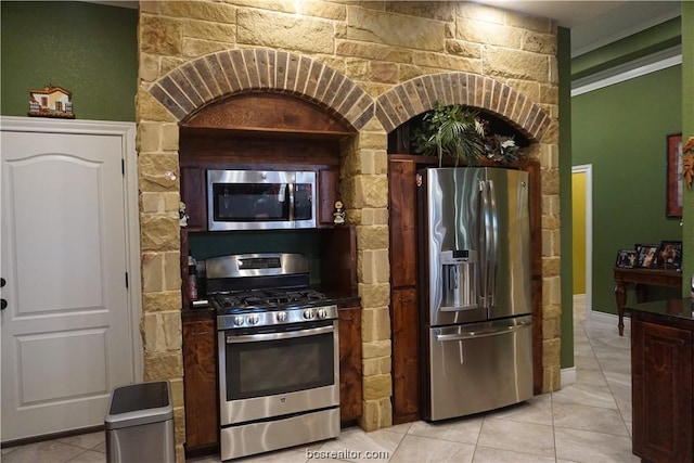 kitchen featuring light tile patterned floors and appliances with stainless steel finishes