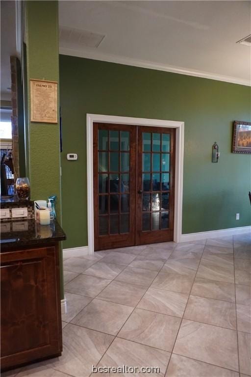 corridor with french doors, light tile patterned flooring, and ornamental molding