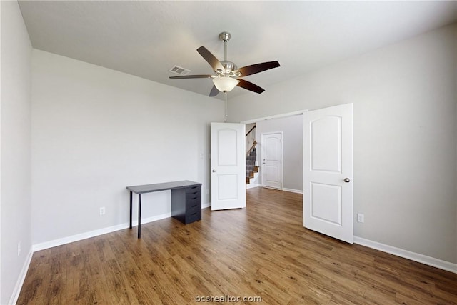 unfurnished bedroom featuring dark hardwood / wood-style floors and ceiling fan