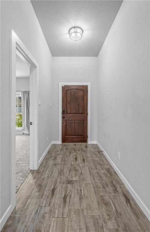 doorway featuring a textured ceiling