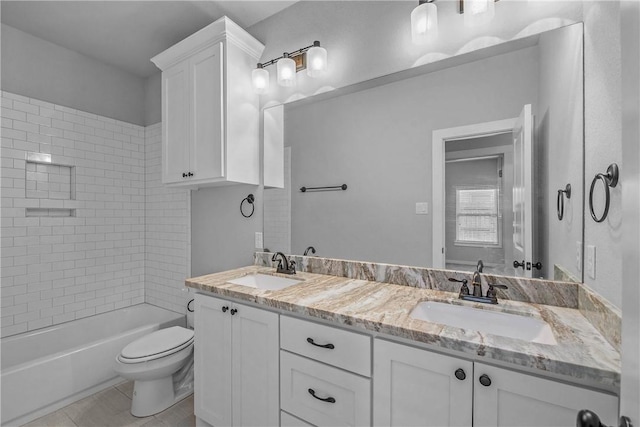 full bathroom with tile patterned flooring, vanity, toilet, and tiled shower / bath