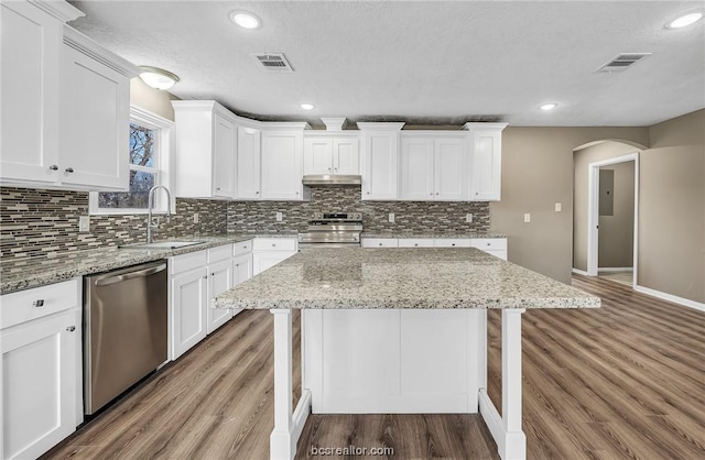 508 N O Neal St, Caldwell, TX 77836 - kitchen featuring white cabinetry, a center island, dark wood-type flooring, and appliances with stainless steel finishes