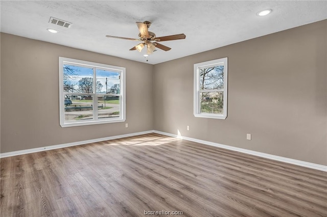 508 N O Neal St, Caldwell, TX 77836 - spare room featuring ceiling fan, a healthy amount of sunlight, a textured ceiling, and light hardwood / wood-style flooring