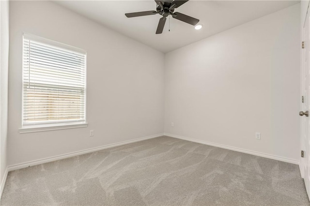 spare room featuring ceiling fan and light colored carpet