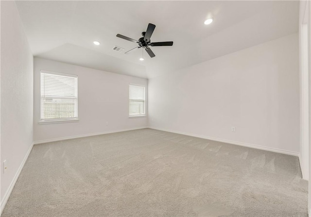 empty room with light carpet, ceiling fan, and lofted ceiling