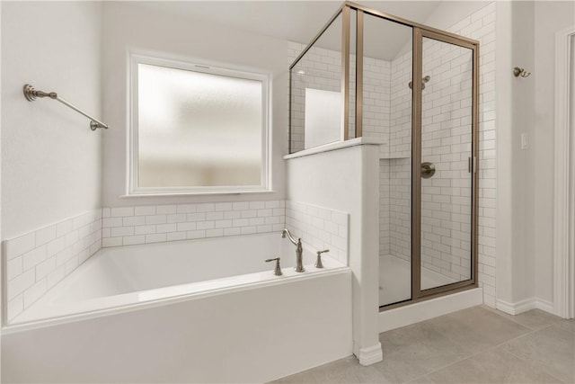 bathroom with shower with separate bathtub and tile patterned floors