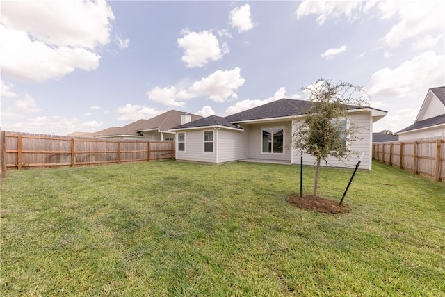 back of house featuring a yard