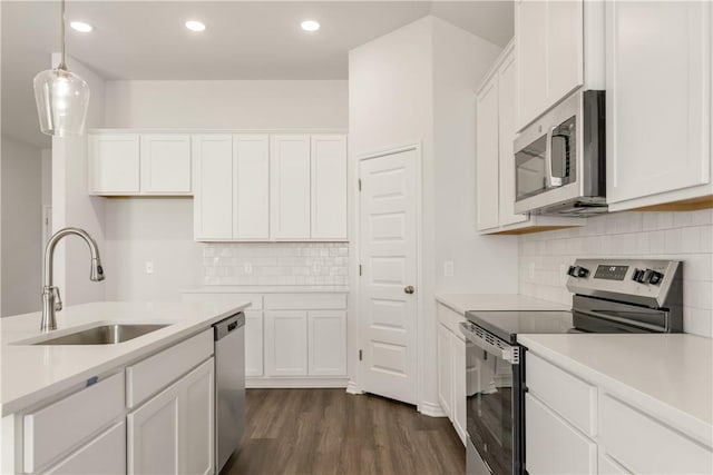 kitchen with white cabinets, sink, and appliances with stainless steel finishes