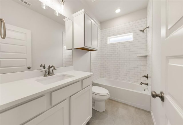 full bathroom with vanity, toilet, and tiled shower / bath