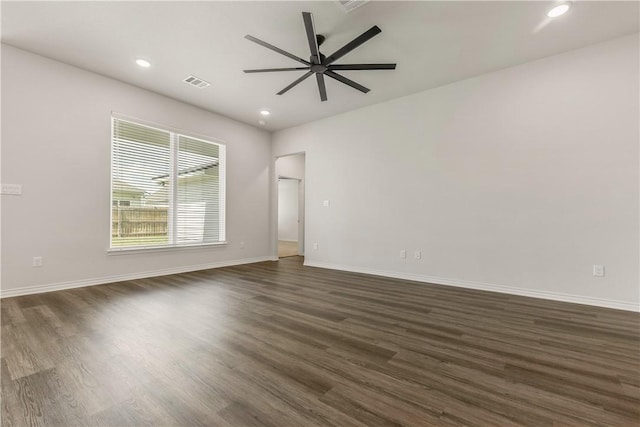 spare room with dark hardwood / wood-style floors and ceiling fan