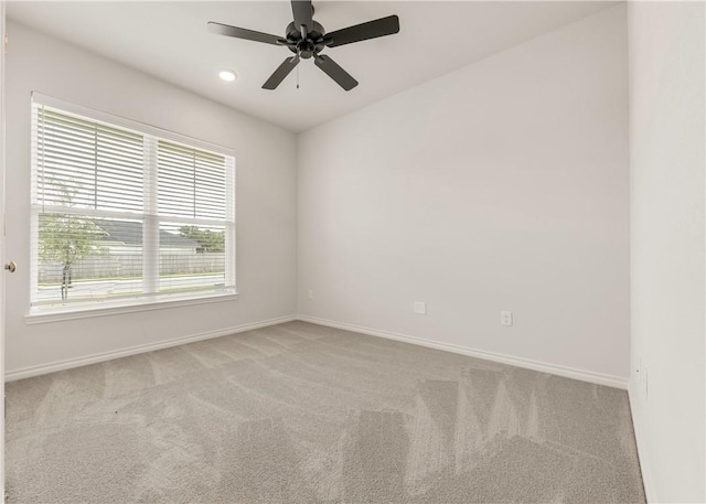 carpeted empty room featuring ceiling fan