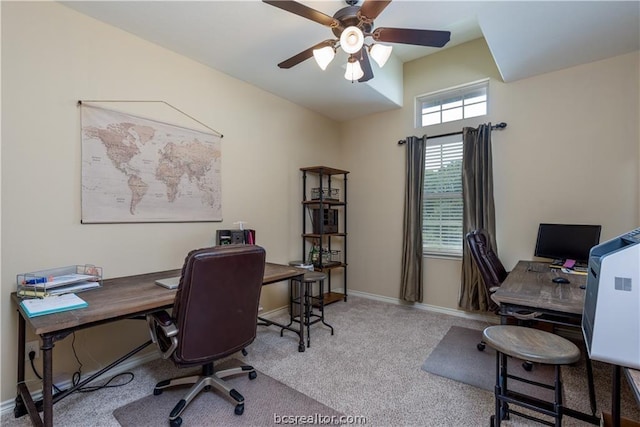 carpeted home office featuring ceiling fan