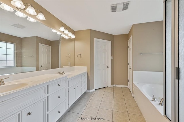 bathroom featuring vanity, a bathing tub, and tile patterned flooring