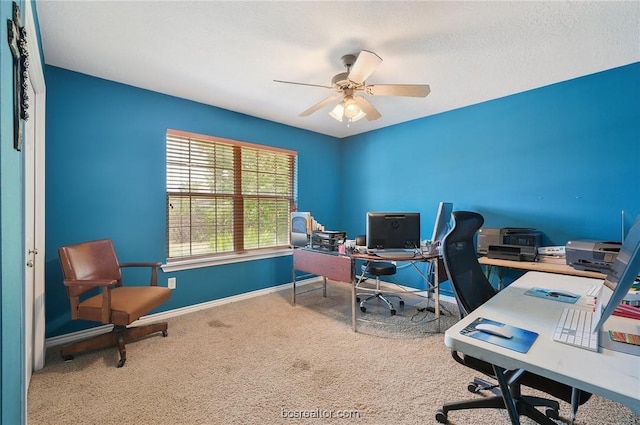 home office featuring carpet floors, a textured ceiling, and ceiling fan