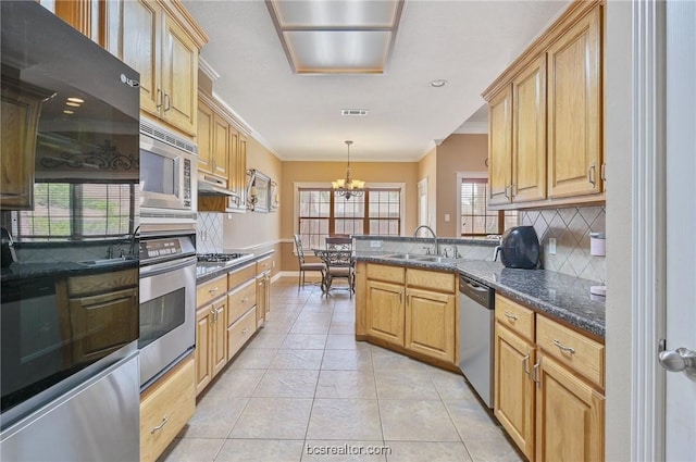 kitchen with light tile patterned flooring, sink, crown molding, hanging light fixtures, and stainless steel appliances