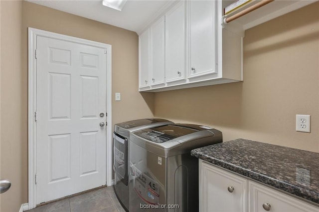 washroom featuring cabinets, light tile patterned flooring, and separate washer and dryer