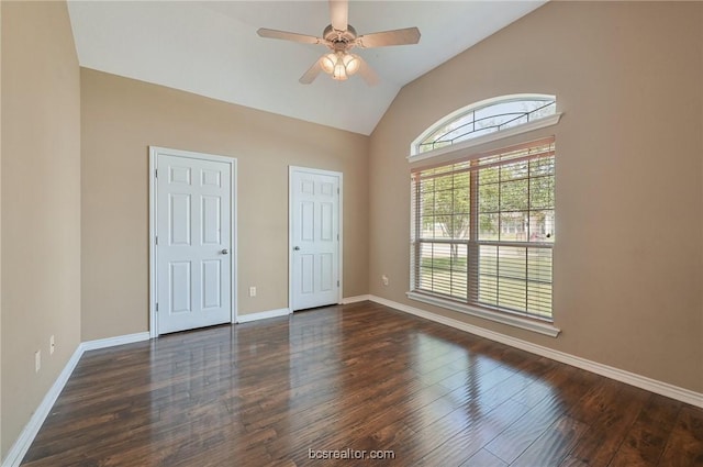 unfurnished bedroom featuring lofted ceiling, dark wood-type flooring, and ceiling fan