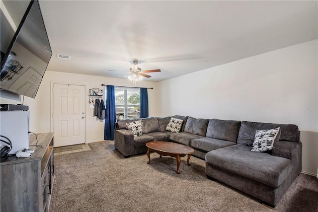 carpeted living room with ceiling fan