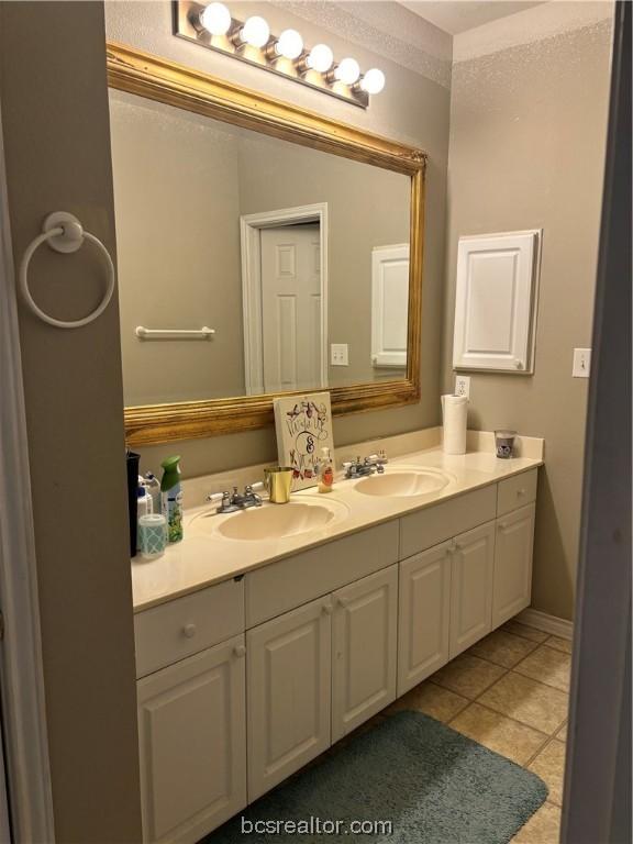 bathroom featuring tile patterned flooring and vanity